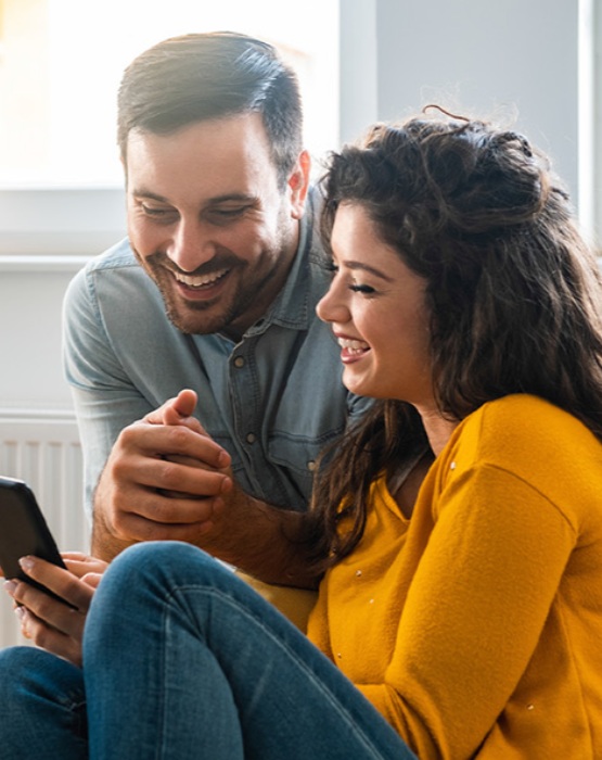 a couple looking at their mobile phone