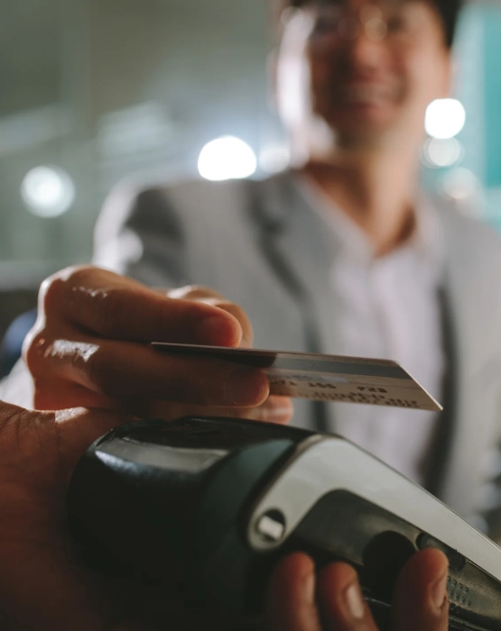 a person using a debit/credit card for a purchase