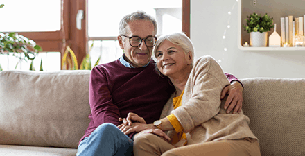 Happy senior couple relaxing together at home