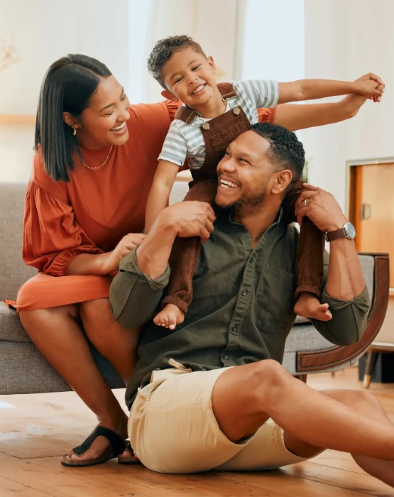 a family of three smiling