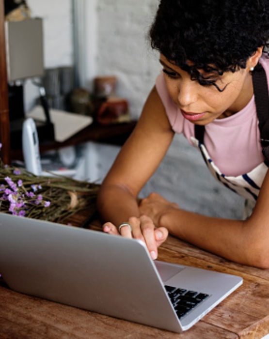 a woman looking at her laptop computer