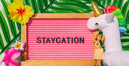 Staycation sign for summer vacation plans