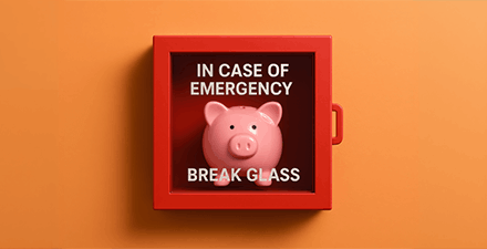 Emergency Savings Conceptual image showing a pink piggy bank inside a red box labeled "In Case of Emergency, Break Glass,"
