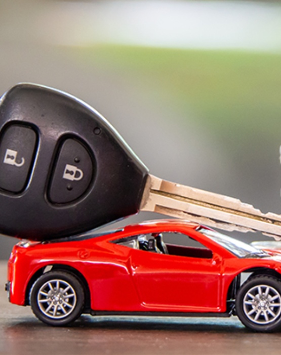 car keys on top of a red model car