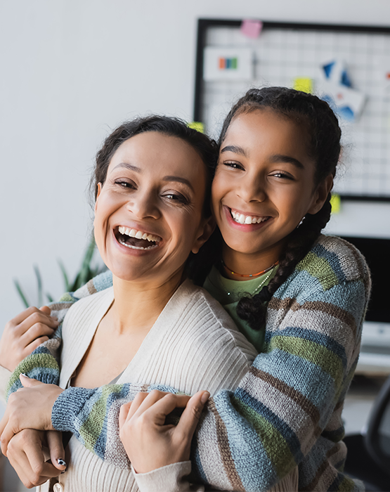 Mother and teenage daughter embracing