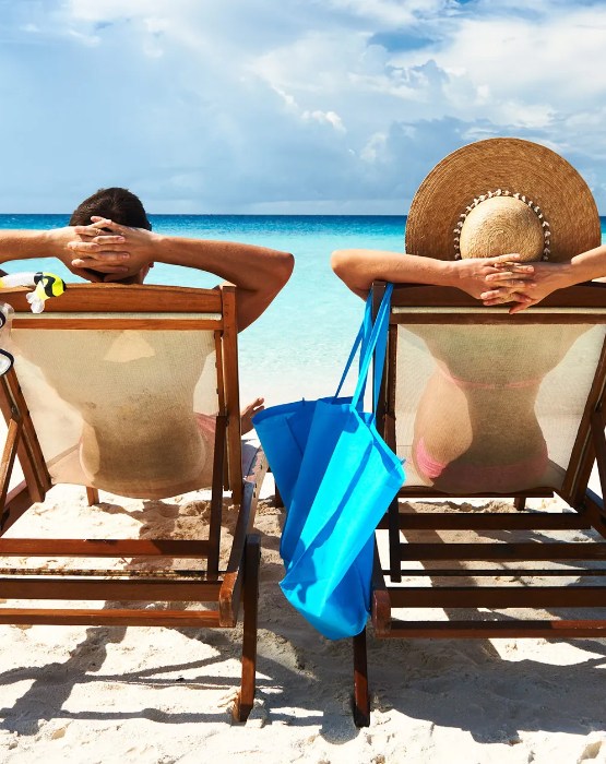 a couple relaxing in beach chairs at the beach