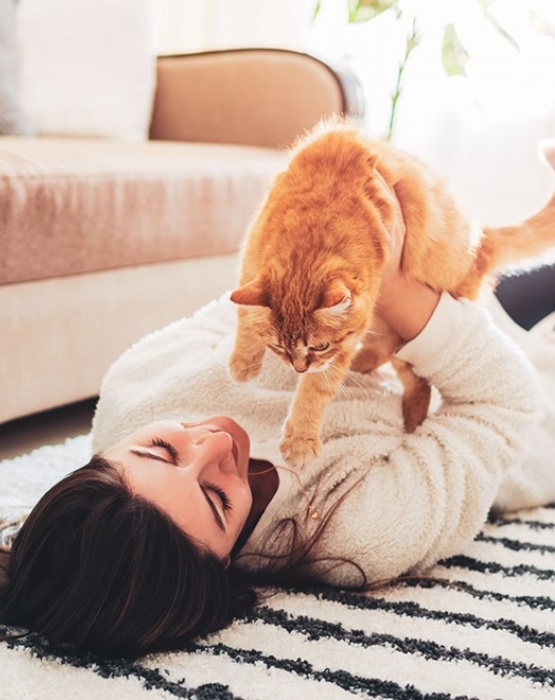 a lady playing with her cat