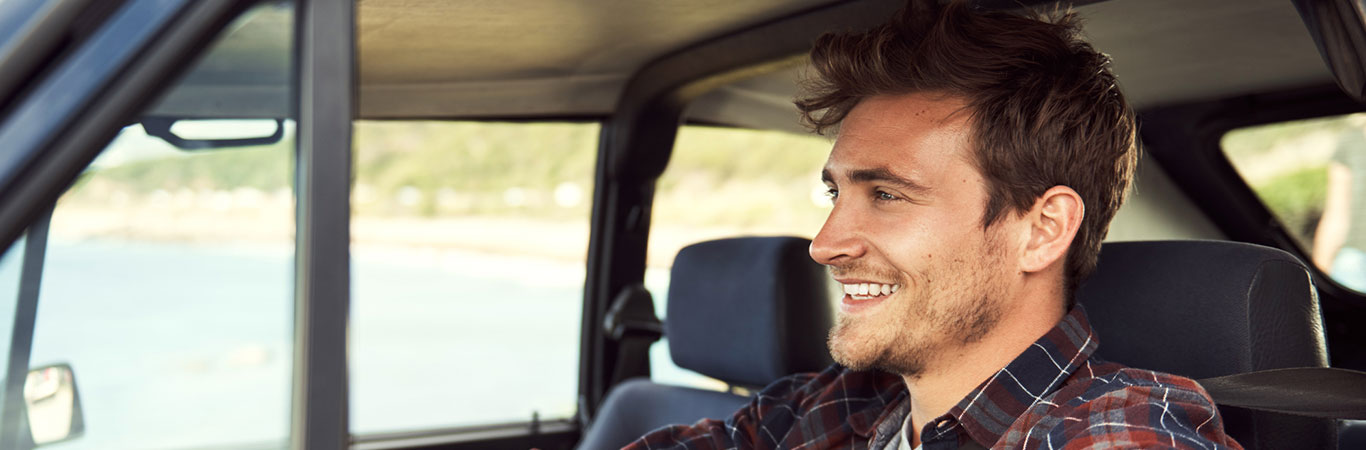 a man driving in his automobile