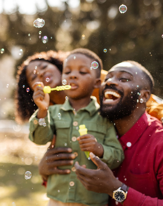 family blow bubbles outside