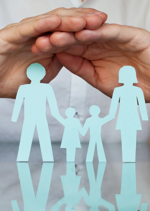 paper cutouts of a family of four with two hands on top