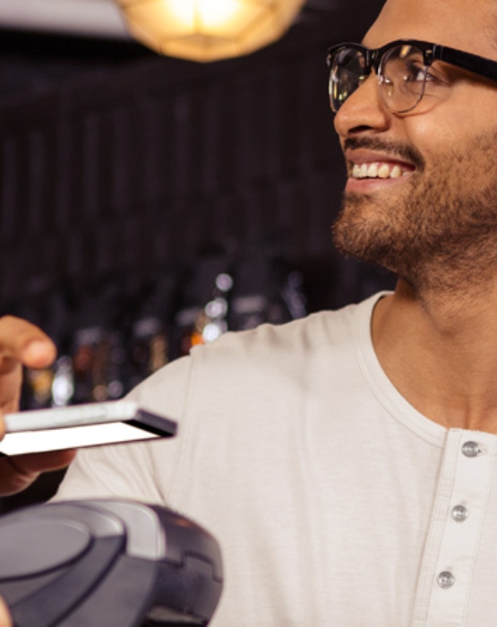 a man paying using his mobile phone