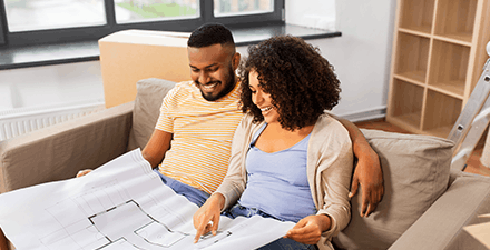 Couple looking at blueprints