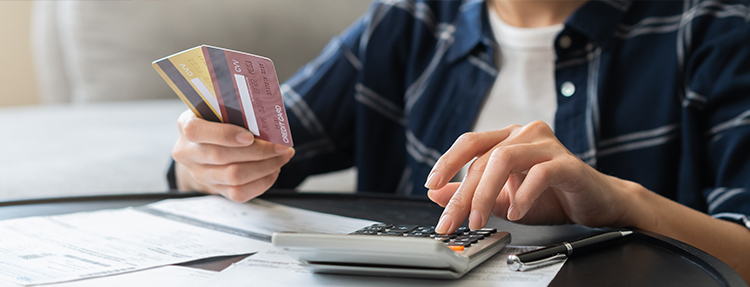 Person calculating credit card balances.