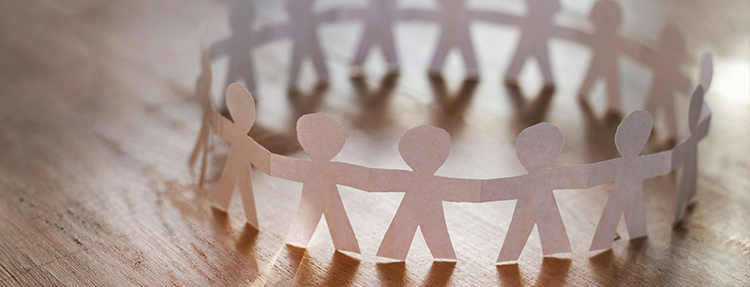 Paper people cutouts holding hands